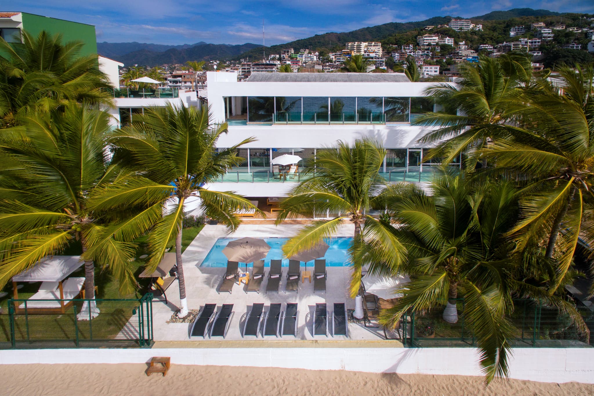 Casa La Playa on the sand at Playa Camarones with downtown Puerto Vallarta behind it